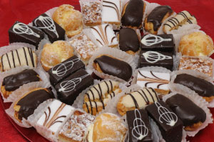 Assortment of mini pastries such as cream puffs, eclairs, and other sweet treats