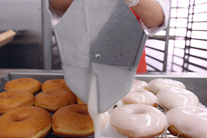 Donuts Being Glazed