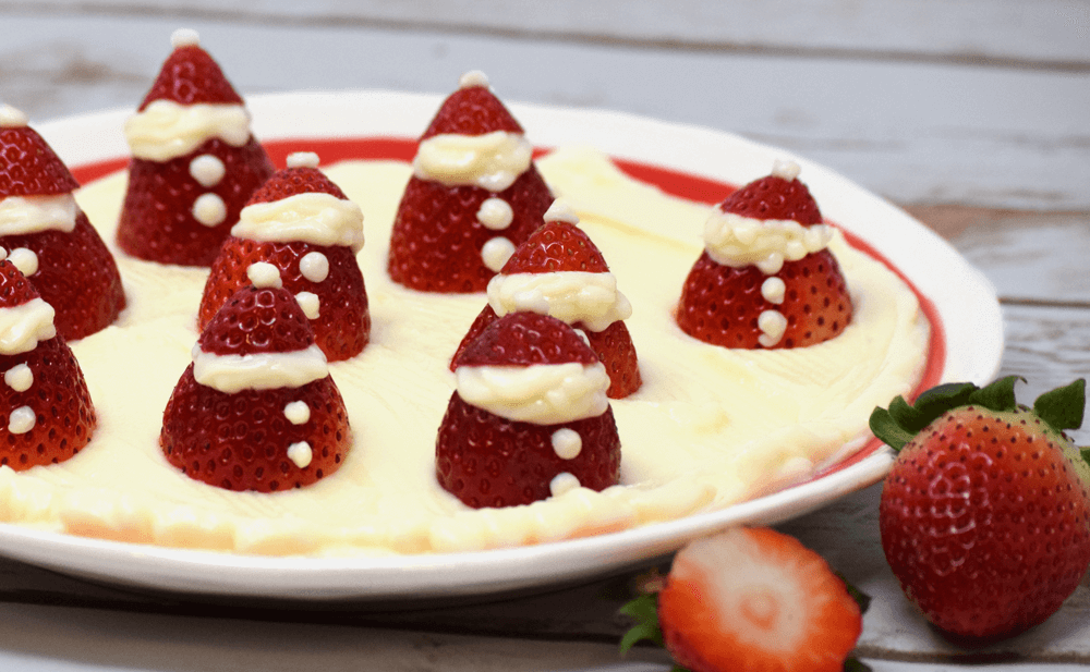 Strawberry Santas on a plate of sweet ricotta cheese
