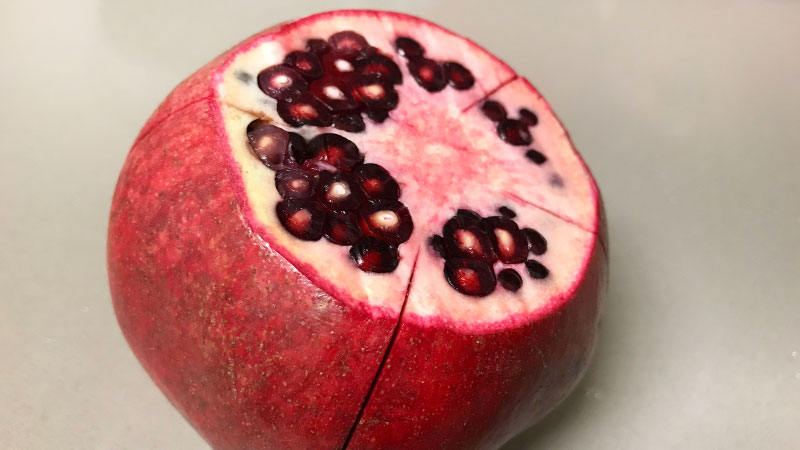 Score the sides of the pomegranate