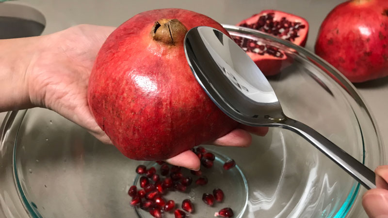 Whack the pomegranate with a spoon