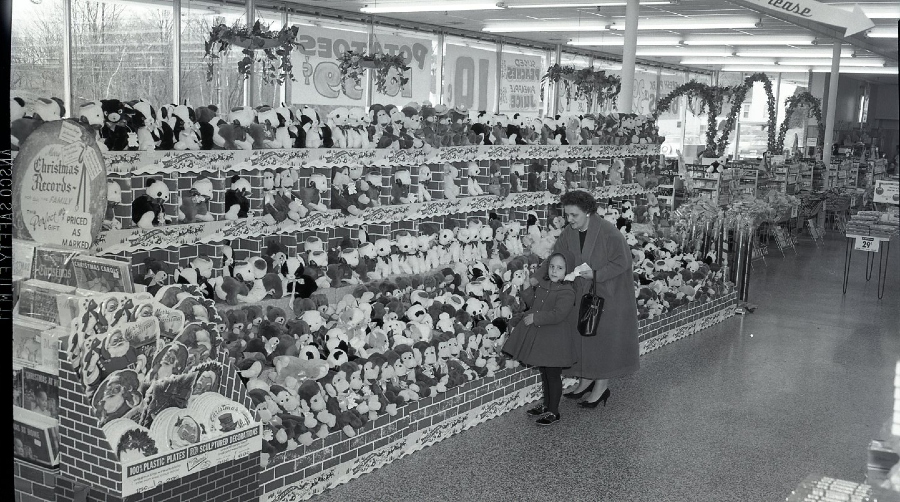 Woman and small girl in front of stuffed toys display